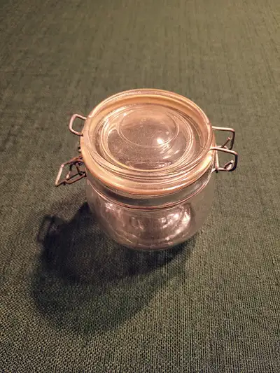 small glass storage jar with attached lid, View more
