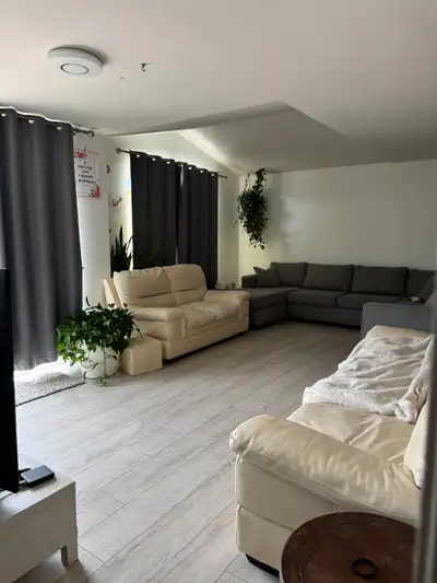 The house features a long driveway, a garage, two spacious living rooms, four bedrooms, and a family...