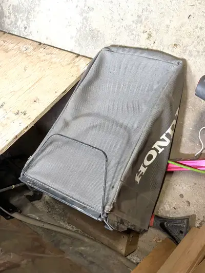 This is a used Honda lawn mower bag in fair condition, perfect for catching grass clippings and keep...