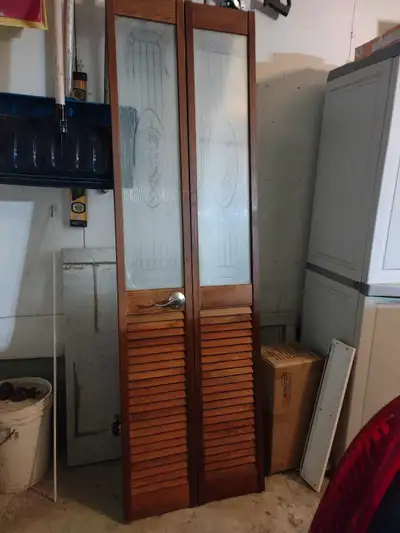 Top half decorative glass and lower half louvered door. The plastic is still on the glass portion. C...
