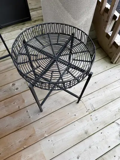 Enhance your outdoor living area with this sleek black circular side table featuring a durable metal...