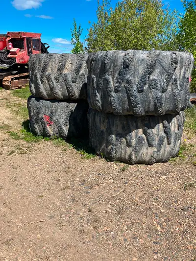 35.5-32 forestry tires 26 ply and double ring bear claw chains , 30.5-32 skidder tires on John deere...