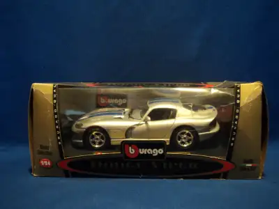This silver Dodge Viper with blue stripes is in mint condition. The box is damaged as seen in the pi...
