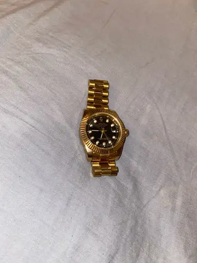 Gold with black interior Rolex watch, View more