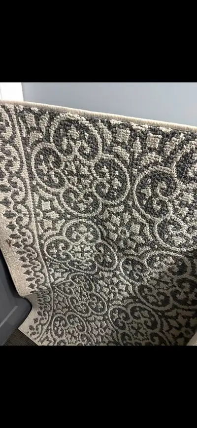 Add a touch of elegance to your floors with this stylish gray and beige patterned rug, perfect for a...