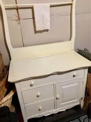 Antique wash stand in distressed white finish. Measures 57 inches high, 17 inches in depth and 34 in...