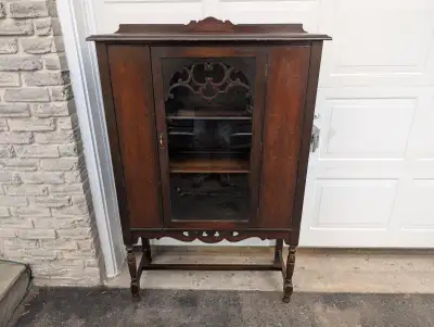 Beautiful solid wood and real wood veneer with one centered glass door. Weathered and rustic finish...