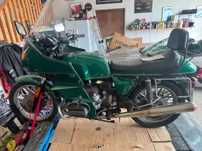 This 1982 BMW R100RT is a classic touring motorcycle project that features a distinctive green finis...