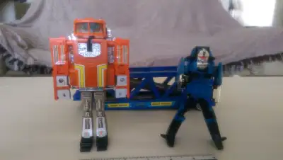 The original Transformers by a few weeks. You'll get 2 Bandai Tonka Mighty Vehicles. ID 023 "STAKS"...