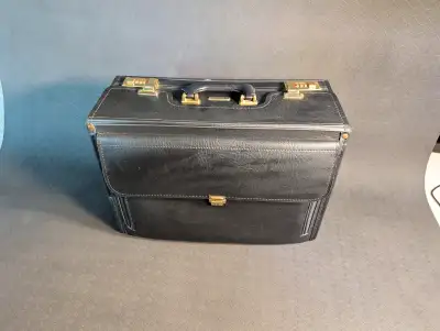 Helping parents condense their belongings. Old Scradellina Briefcase that has seen use but could sti...