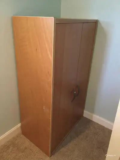 This is a used Ikea wardrobe with a blonde wood finish, perfect for adding storage to any room. It h...