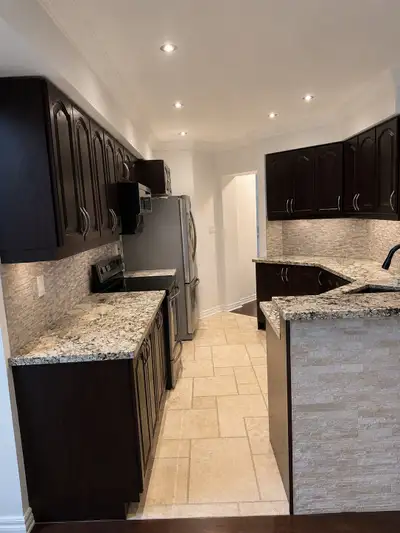 Solid wood kitchen cabinets like new, brown color with free fridge, microwave and electric cooker an...