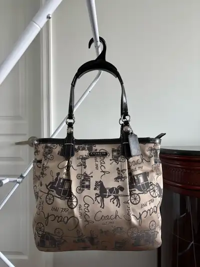 Khaki jacquard with signature horse and carriage pattern, black leather trim, silver tone hardware....