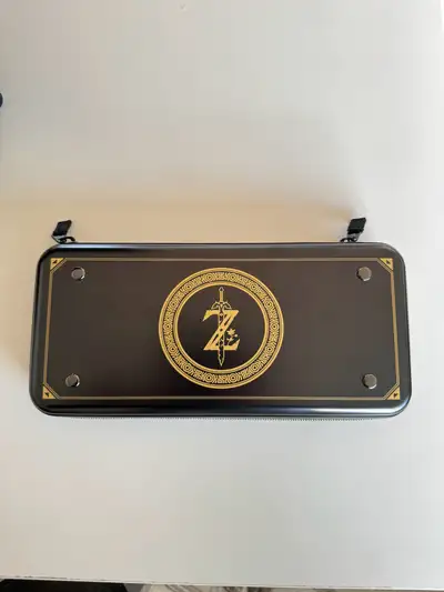 I'm selling a used Zelda-themed carrying case for the Nintendo Switch, adorned with the iconic Hyrul...