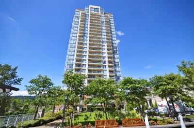 The furnished master bedroom with a private bathroom and walk-in closet in this 2-bedroom condo is a...