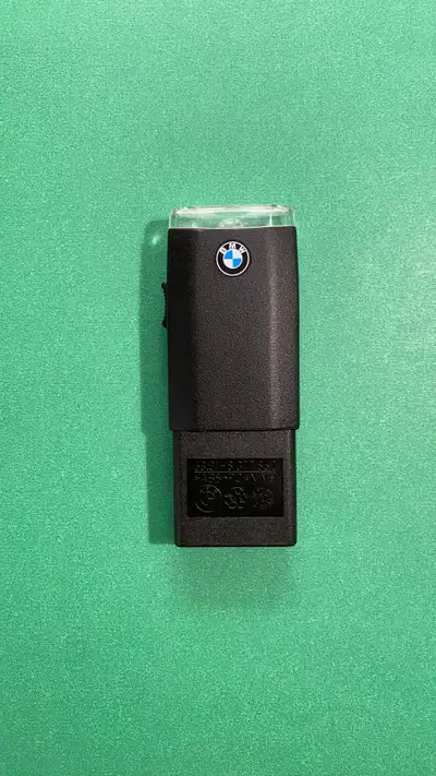 Black rechargeable BMW glove compartment flashlight with the matching receptacle. Part numbers: Flas...