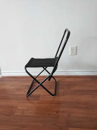 This is a compact and convenient black folding chair, perfect for small spaces or portable seating n...