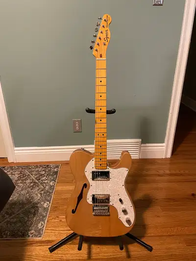 This is a lightly used Squier Thinline Telecaster, ready to plug in and play. It has a beautiful nat...