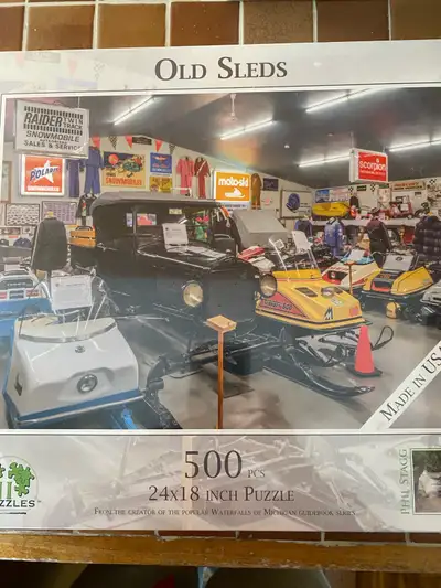 I have a collection of vintage snowmobile memorabilia including a 500-piece 'Old Sleds' puzzle, vint...