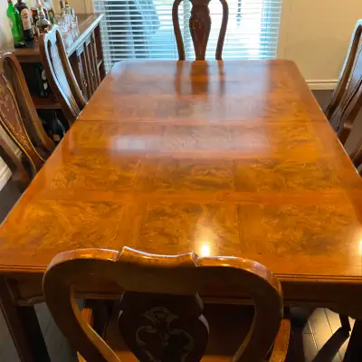 Solid wood Italian style wood table with inlays. Seats 8. Includes two captains chairs and six regul...