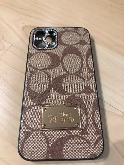 $15 OBO. COACH IPHONE 11 PRO CASE. PERFECT SHAPE. NO DAMAGE AT ALL. . CALL OR TEXT 780 655 8516