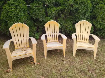 3 Comfortable Plastic Yellow Adirondack Chairs ( weathered) . Need to be power washed