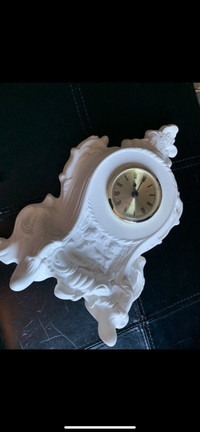 White decorative clock with yellow face and Roman numbers