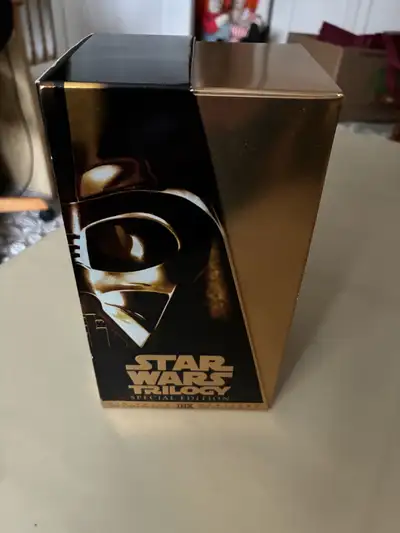 Own a piece of cinematic history with this Star Wars VHS Trilogy Special Edition set. This collector...