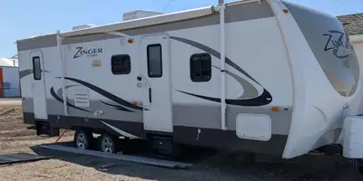 2013 camper with large slide out, new awning fabric. Stabilizer hitch and waste water cart included