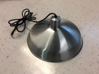 A new, 16” in diameter, stainless steel shade pendant light fixture with white enamelled reflective...