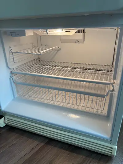 Whirlpool fridge with freezer on bottom fridge works excellent clean and ready for your second fridg...