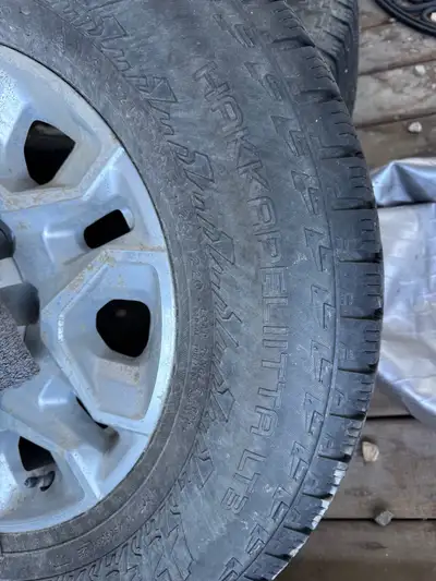 These are a set of used Chevrolet rims and tires, perfect for winter driving with their studded Noki...