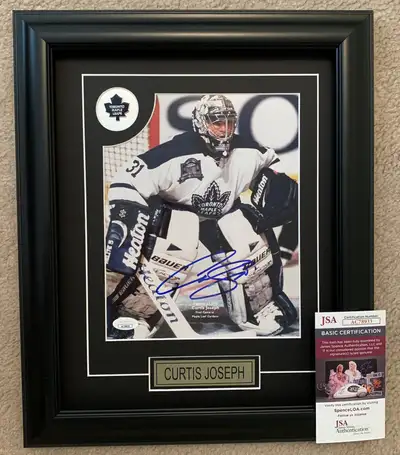 This is an 8" x 10" hand signed photo of Curtis Joseph framed in black with black matting, Toronto M...