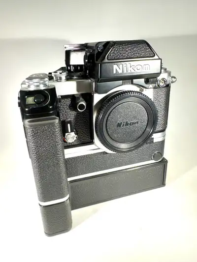 Capture timeless moments with this vintage Nikon F2 film camera, complete with a motor drive for rap...