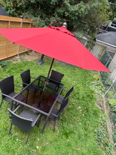 Outdoor table set with umbrella., View more