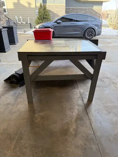 Selling sturdy 3x4 work bench or garage island with metal top. We live in south Edmonton.
