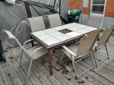 3'x5'x32" high. All metal frame brown. 4 Folding chairs, 2 fixed chairs. Has 14 ceramic tiles for a...