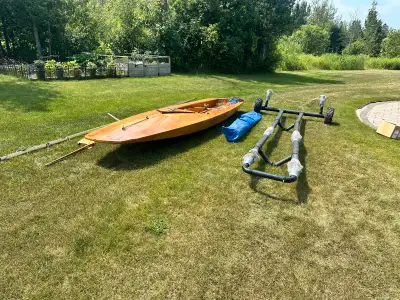 I am selling a used 14’ wooden sailboat, perfect for a day on the lake. While she has seen some adve...