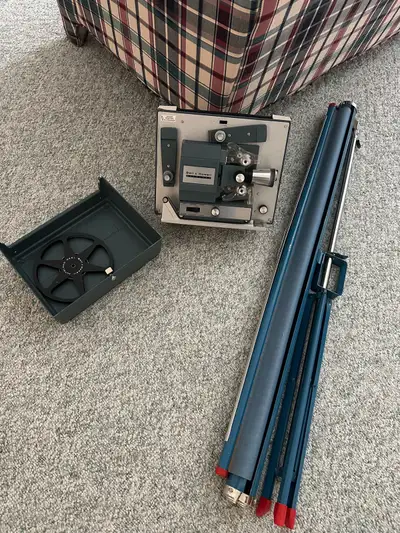 Vintage Bell and Howell Super 8 movie projector and 40” screen
