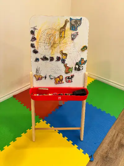 Reversible wooden easel purchased from Mastermind Toys Magnetic whiteboard on one side, chalkboard o...