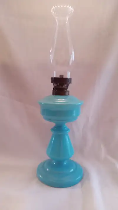 A RARE VINTAGE TURQUISE GLASS OIL LAMP WITH ORIGINAL BURNER POSSIBILY FRENCH AROUND 1900'S. THE PERS...