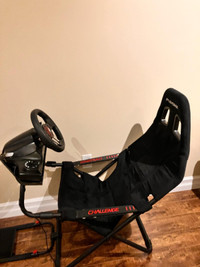Challenge gaming chair with steering wheel and pedals.