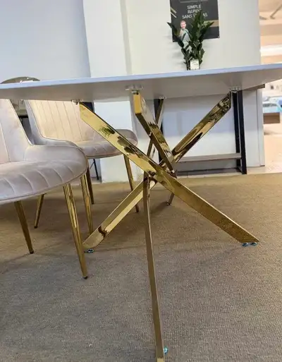 Add a touch of elegance to your dining space with this stylish dining table, featuring a sleek white...