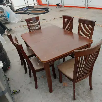Table and 6 chairs with extra leaf $220. Good functional set. Solid chairs could use new covering (c...