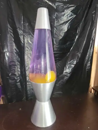 Add some retro flair to your space with this classic purple and yellow liquid motion lava lamp featu...