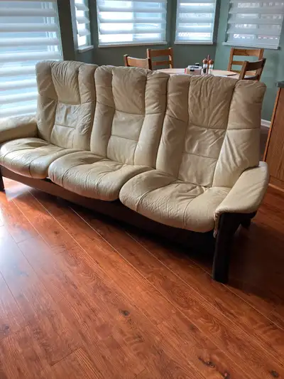This is a 3 seat recliner, cream coloured couch. No rips or tears.