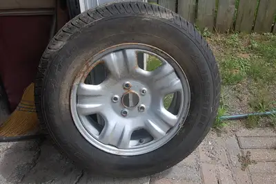 one only 215-70-16 bridgestone tire on toyota rim.never used.also have 4 other rims with used tires...