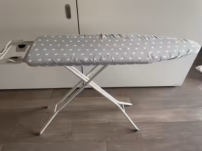 Ironing board, standard size. Grey cover with white polka dots. Cash only.