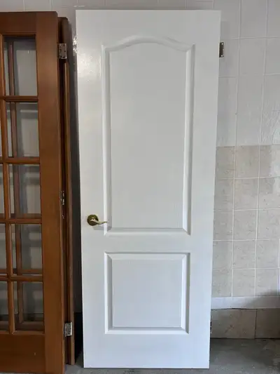 Various solid wood interior doors. Hinges, strike plate and handles included. 4 available - 30" x 80...