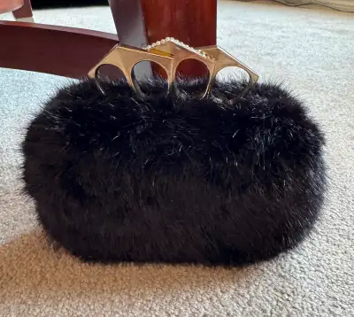 Black fur clutch with brass knuckle handle, View more